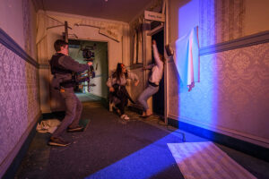 Screen Studies - man filming girls fighting