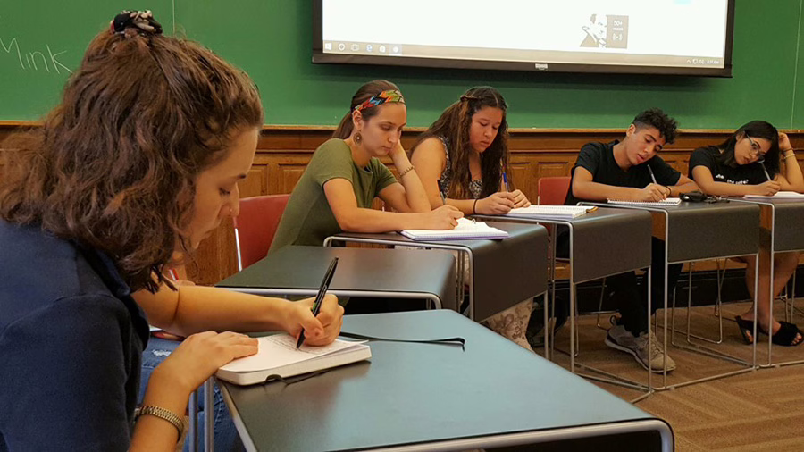 adam achiever student writing in book