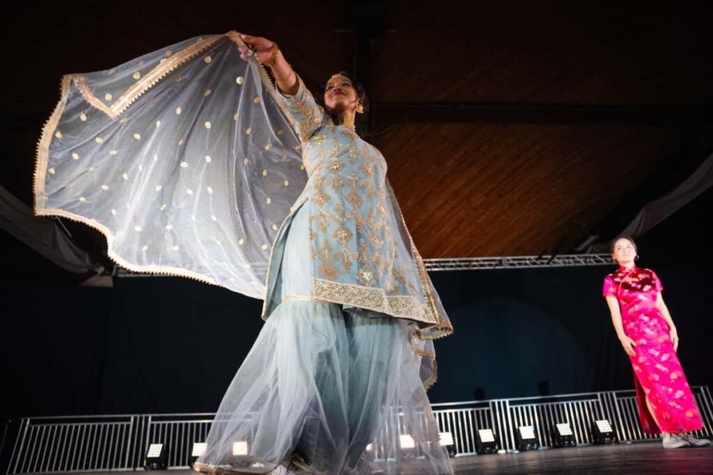 woman on stage with india outfit
