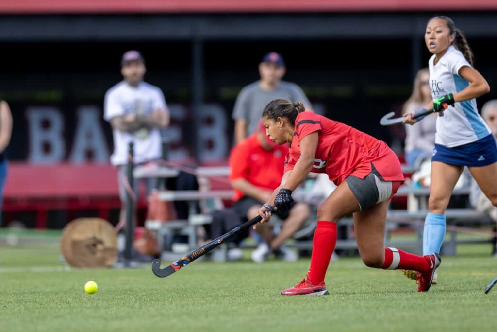 A Clark student athlete plays field hockey