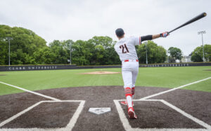 Kyle Bonicki in baseball uniform number 21, swinging a baseball bat