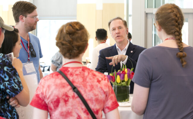 People talking during LGBTQ+ Alumni Reunion Reception