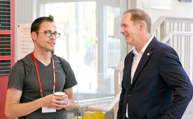 Clark President David B. Fithian speaking with Vladi Highland, CLAA co-leader during the LGBTQ+ Alumni Reunion Reception