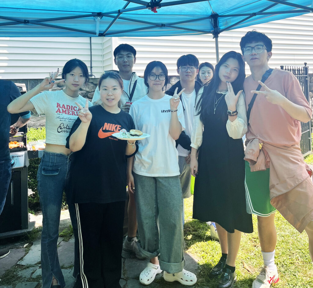 students under canopy with food