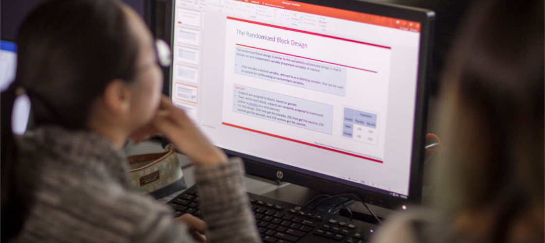 Woman looking at slideshow presentation on computer
