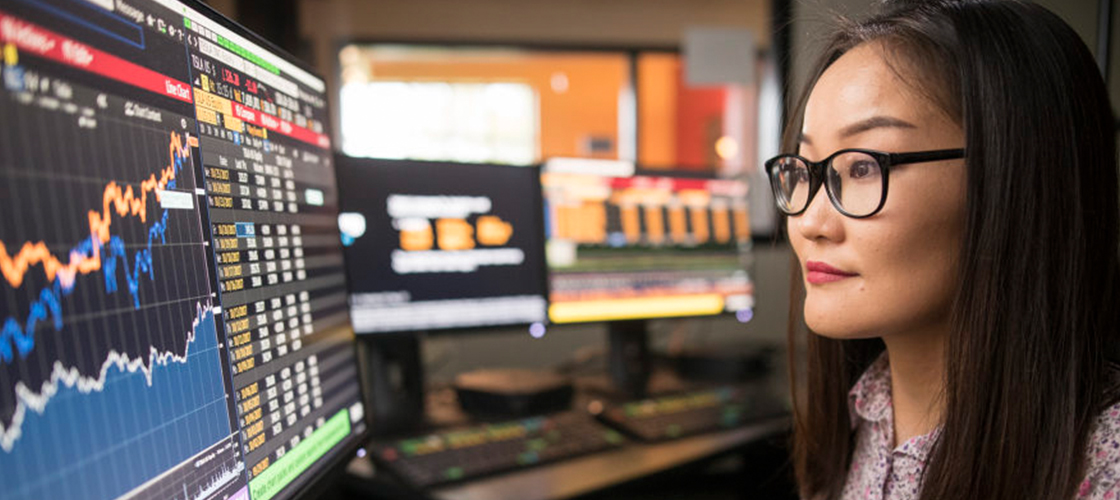 Student looking at computer screen of graphs