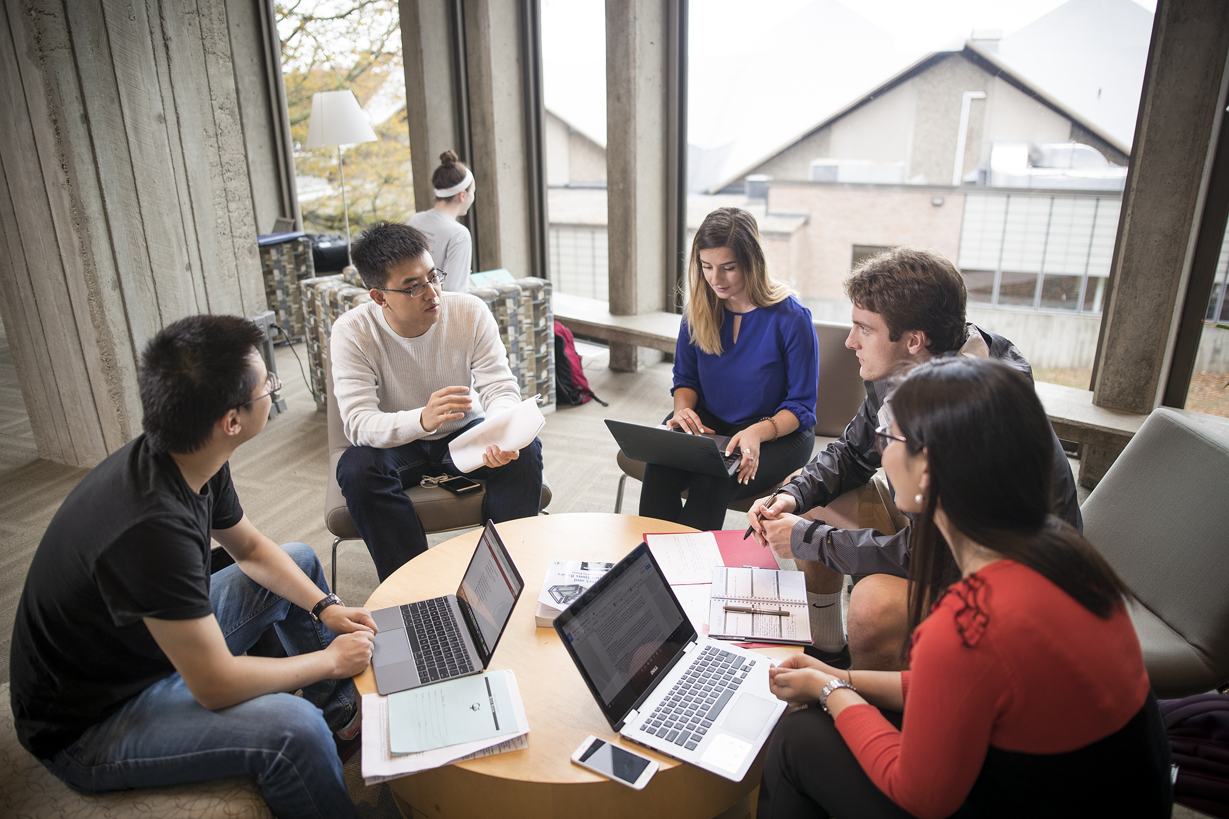 Graduate business students sitting around table