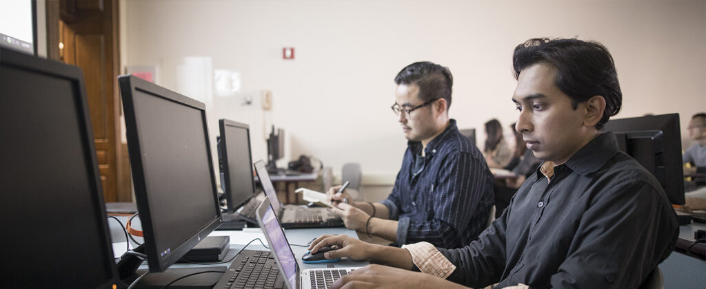 Two students working on computer in lab
