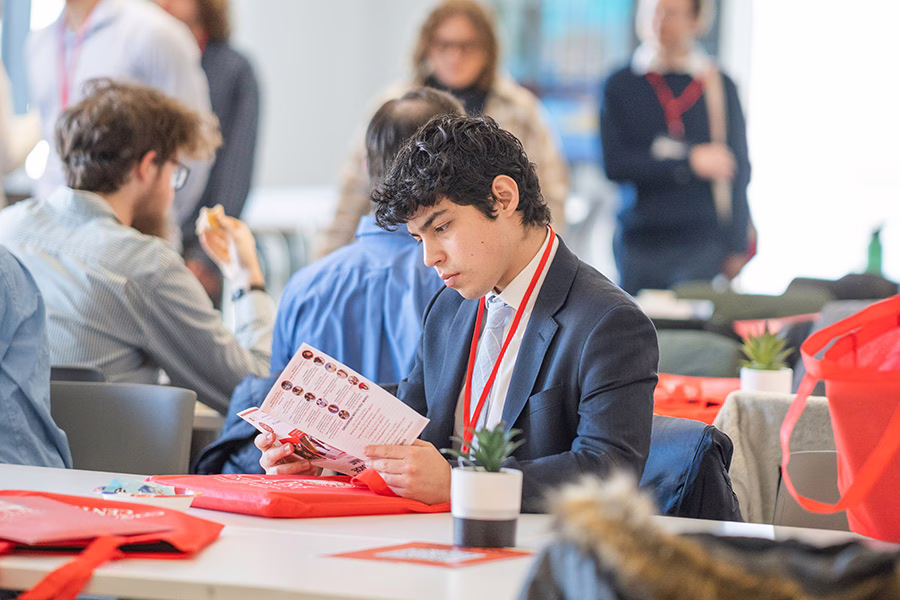 male student looking over booklet