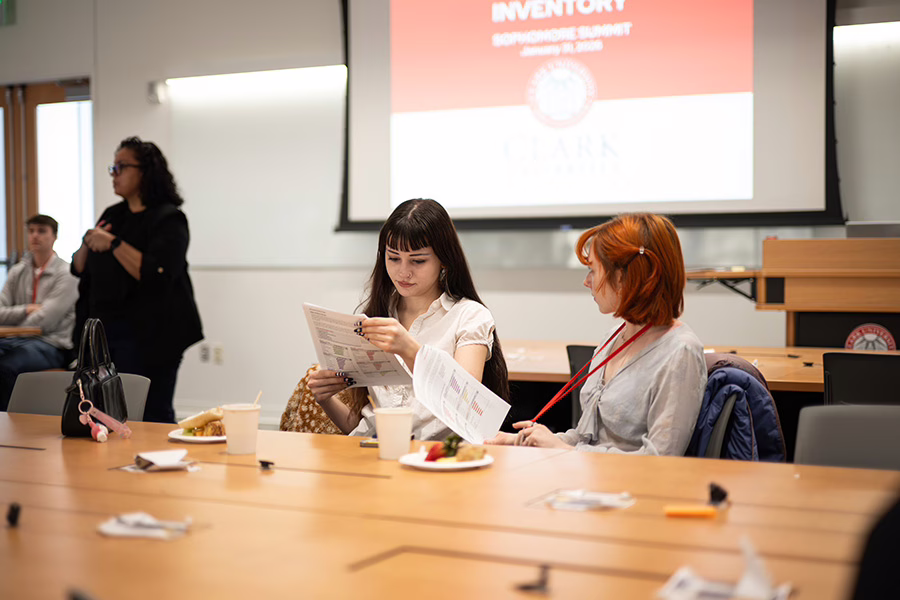 two female students looking over agenda