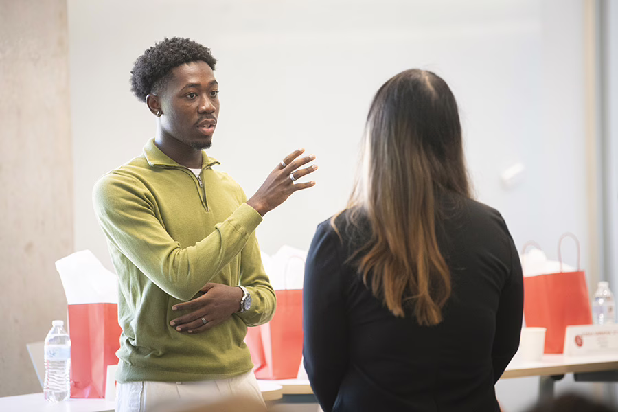 young man talking to female student