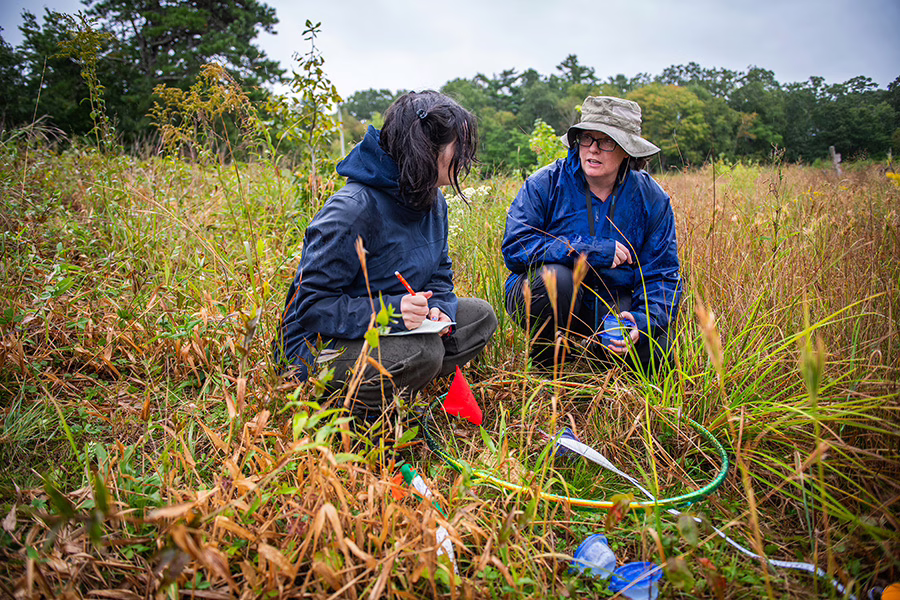 professor in field with student