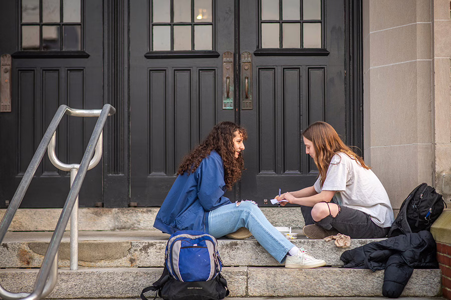 two girls sitting on steps
