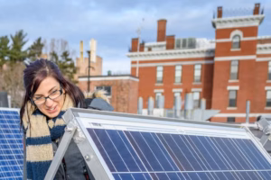 Megan McIntyre inspects solar panels