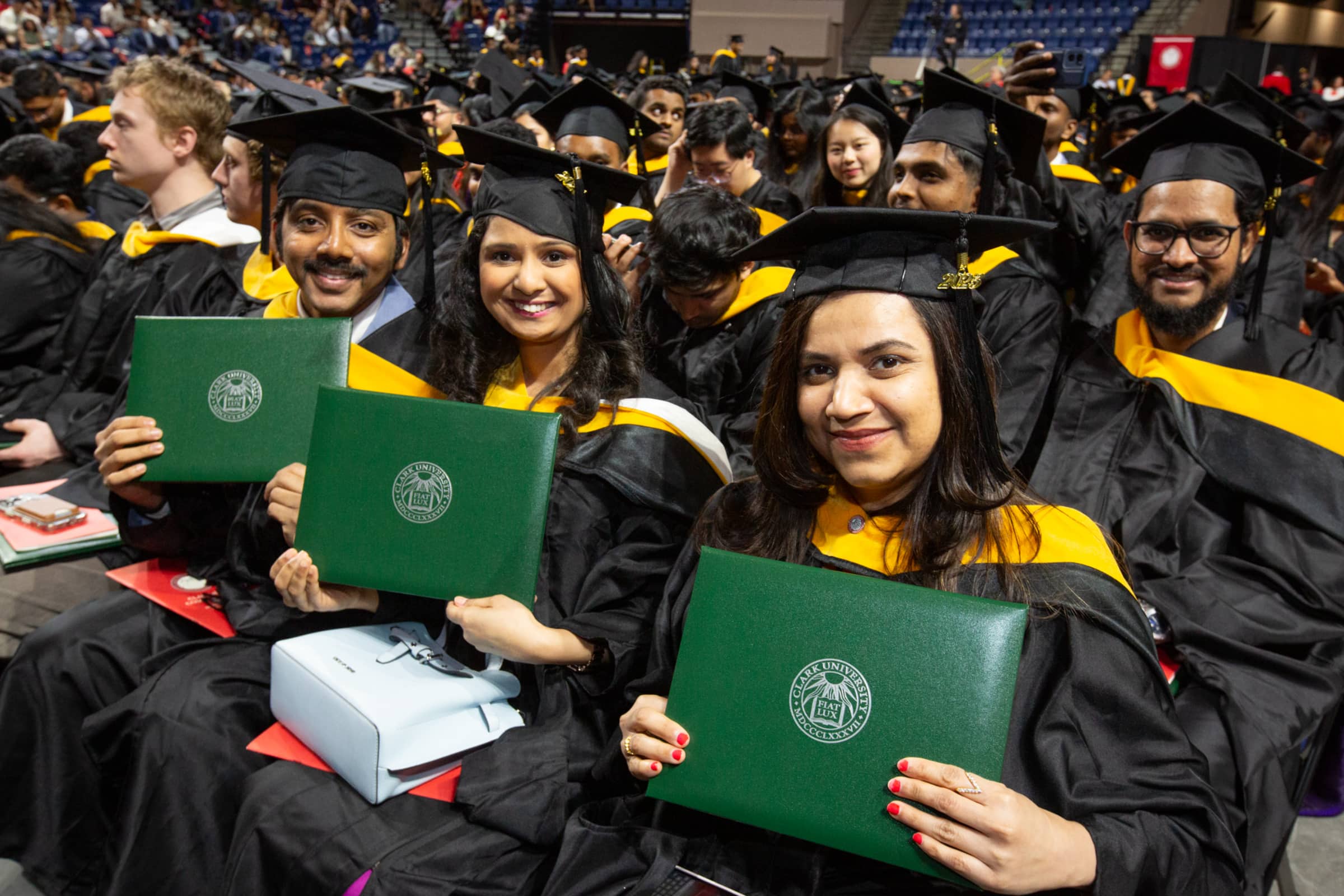 graduates show their diplomas
