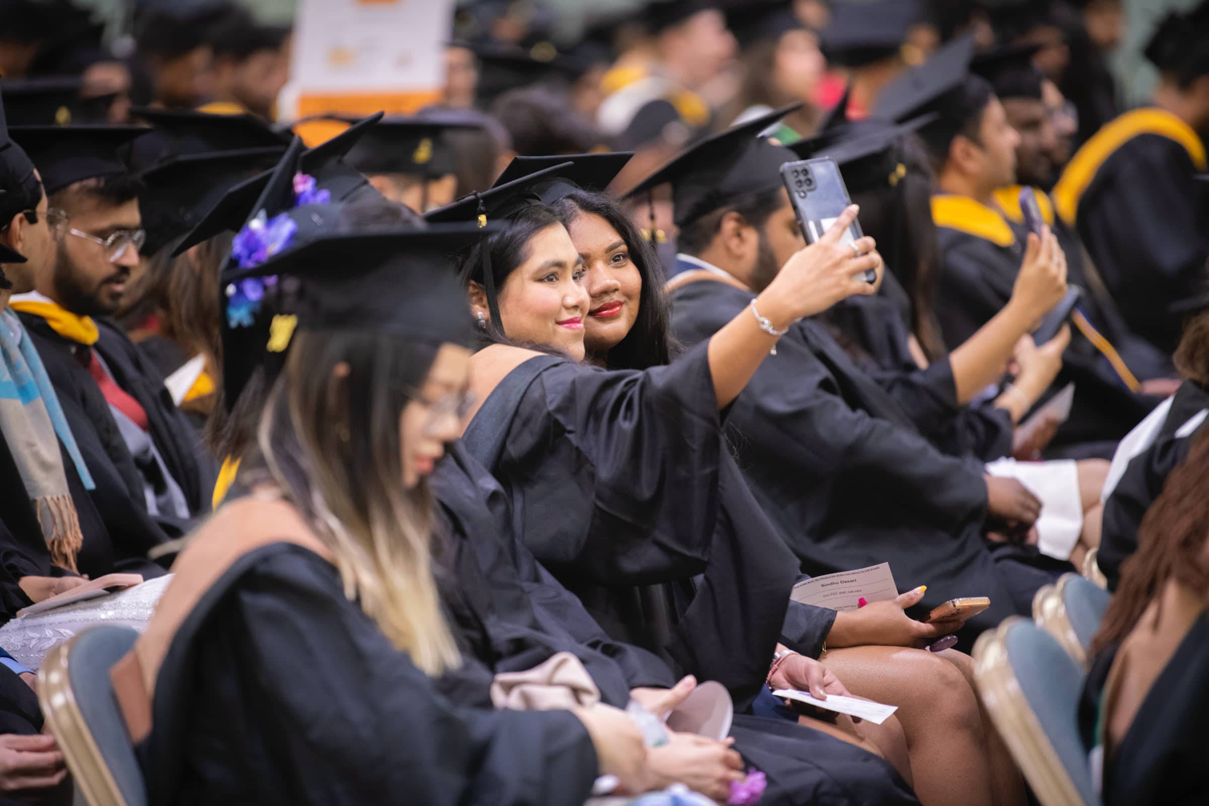 graduates pose for a selfie