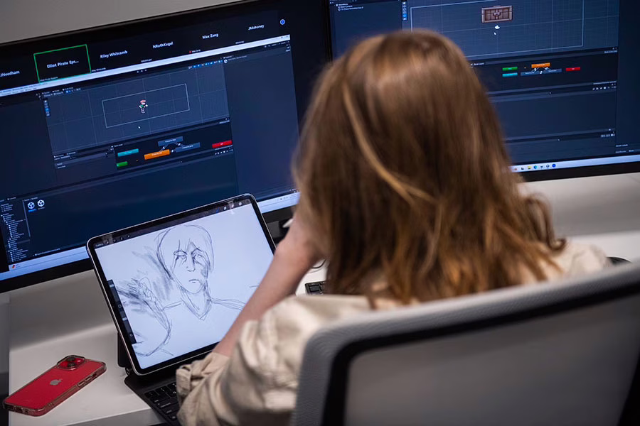 A student works on a digital drawing for a game design class at Clark University