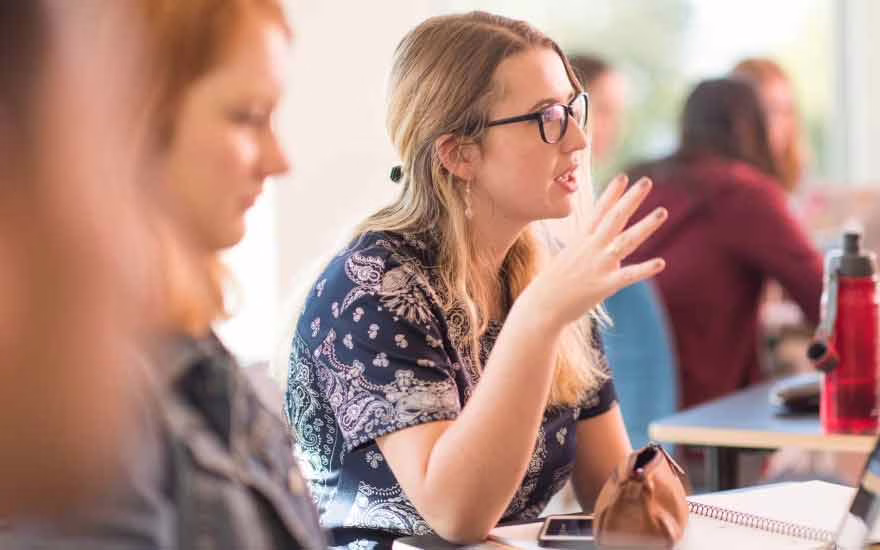 A psychology student participates in a class discussion