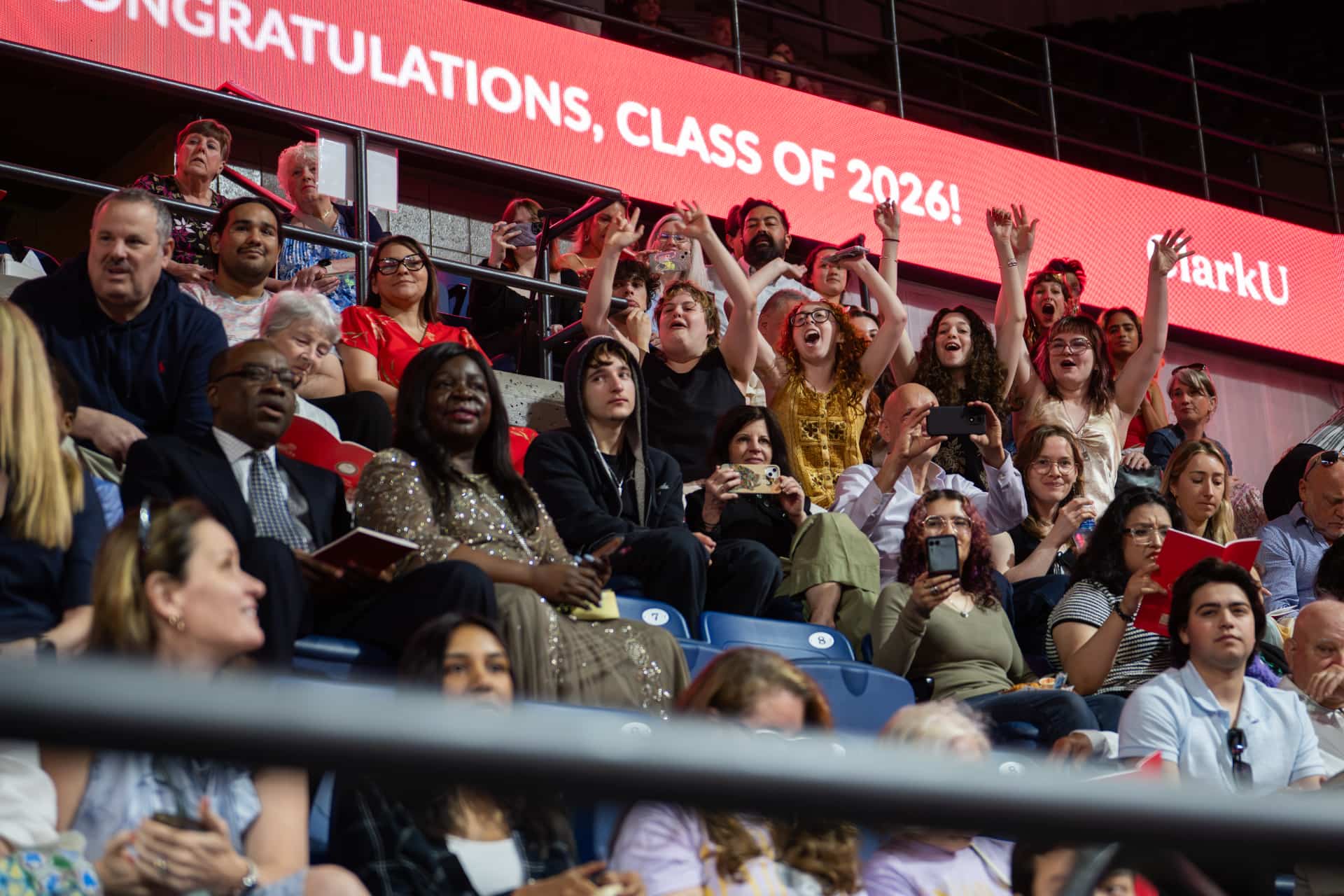 family and friends cheer from the stands