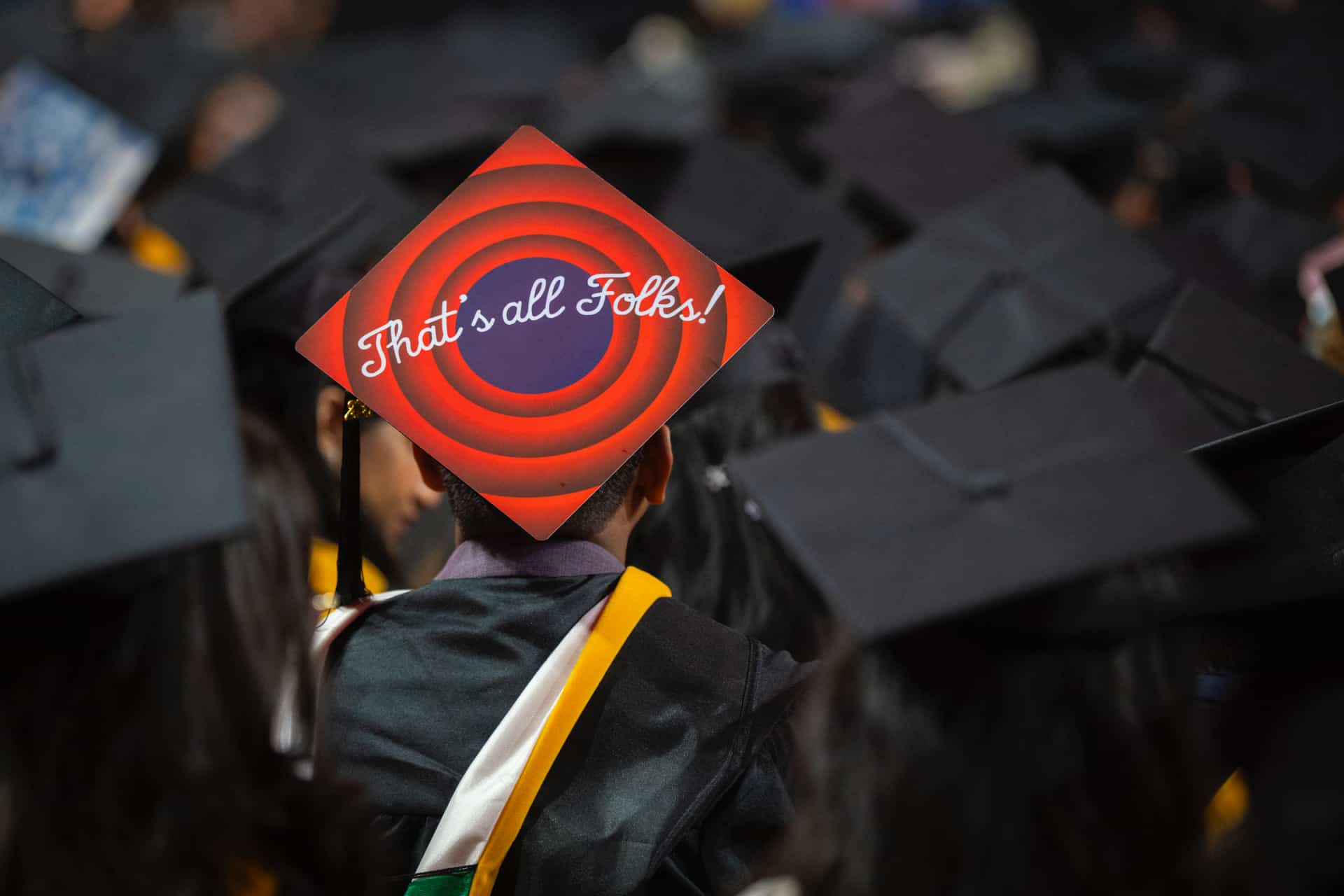 a mortarboard with the art, "That's all folks!"