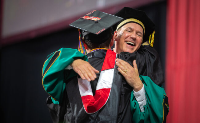 President Fithian hugging student