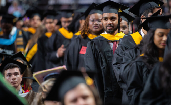 Students walking down aisle