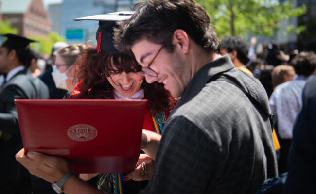 Two students looking at diploma