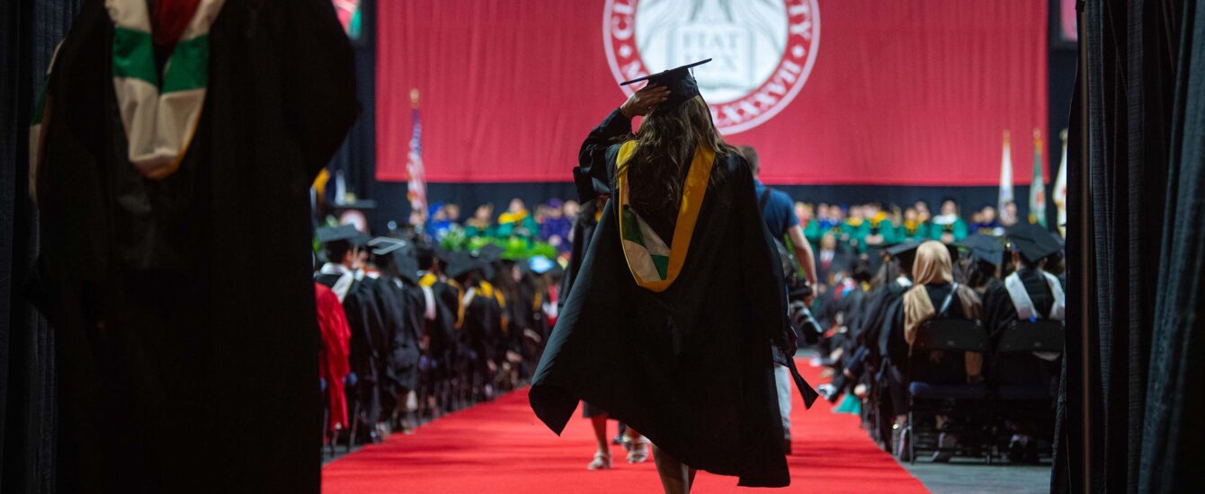 A student walking out towards the stage during Commencement 2024