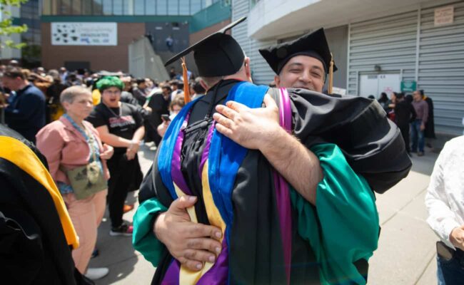 Students hug after the ceremony