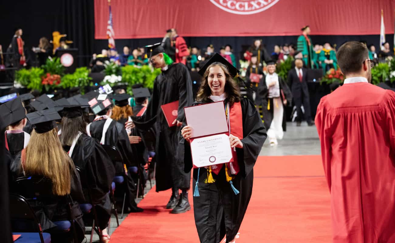 A student shows off her diploma right after receiving it