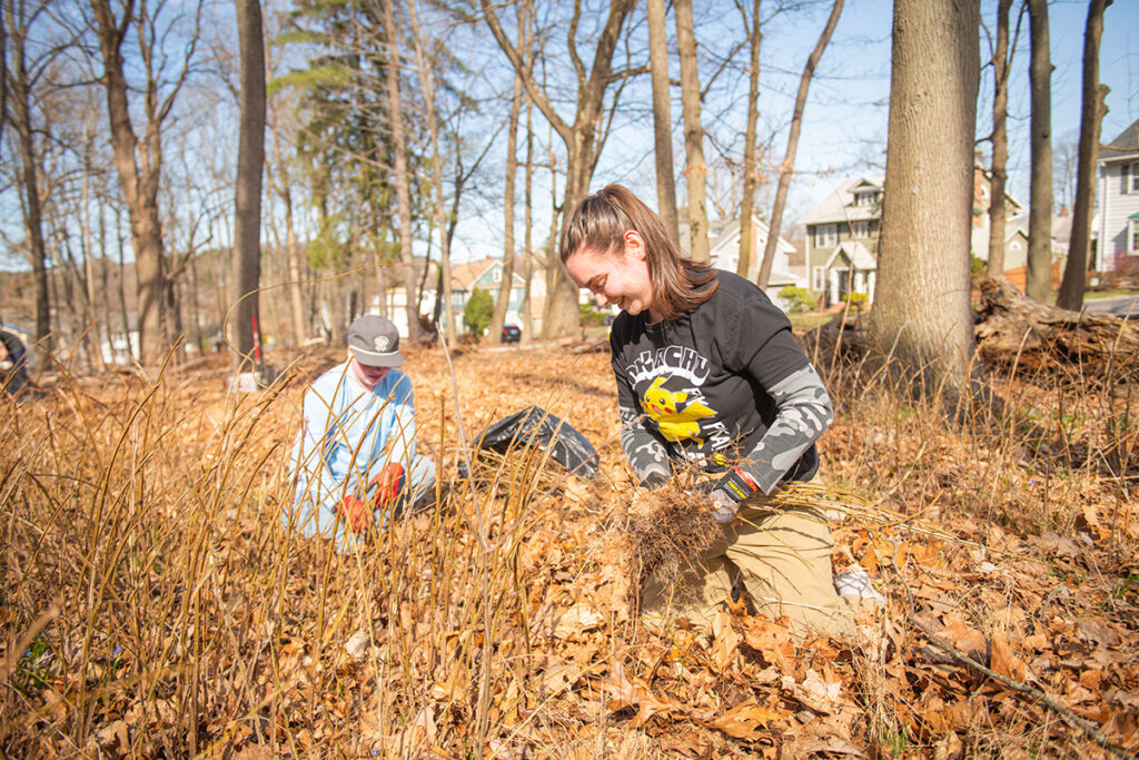 kids in the fall leaves cleaning up debris