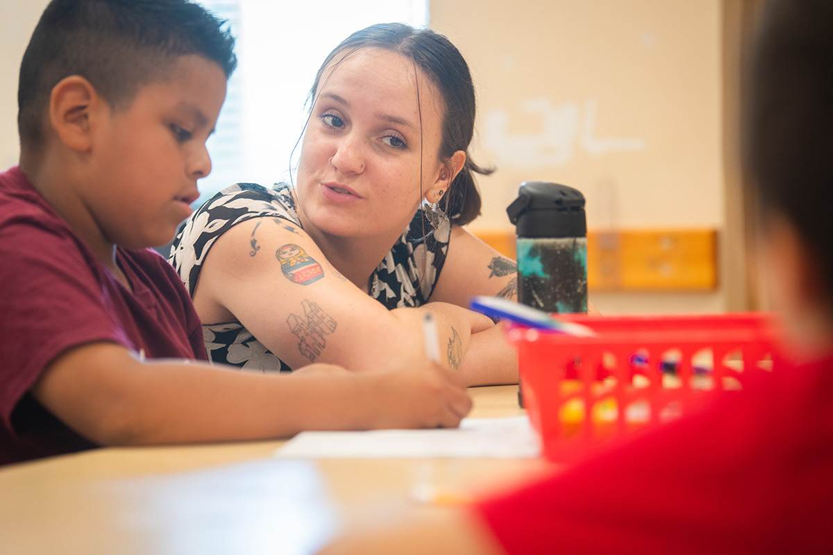 female student working with young child