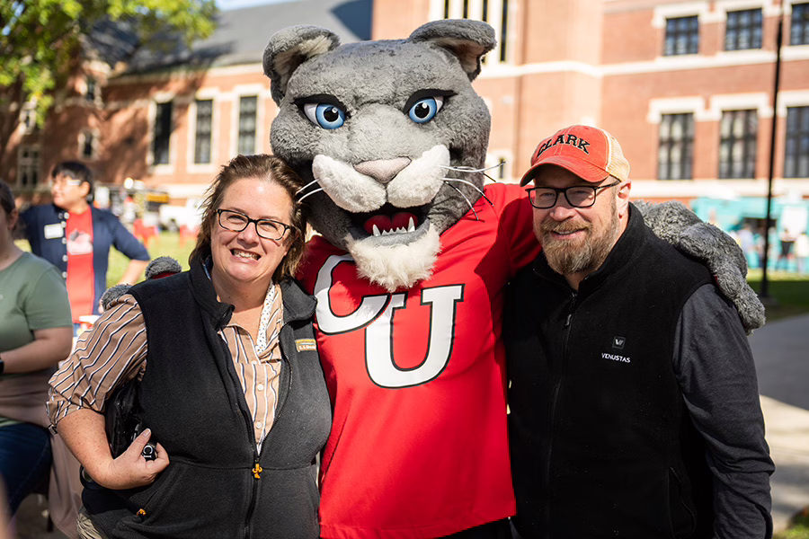 family posing with mascot