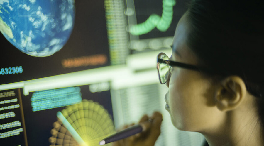 student looking over data analytics on computer