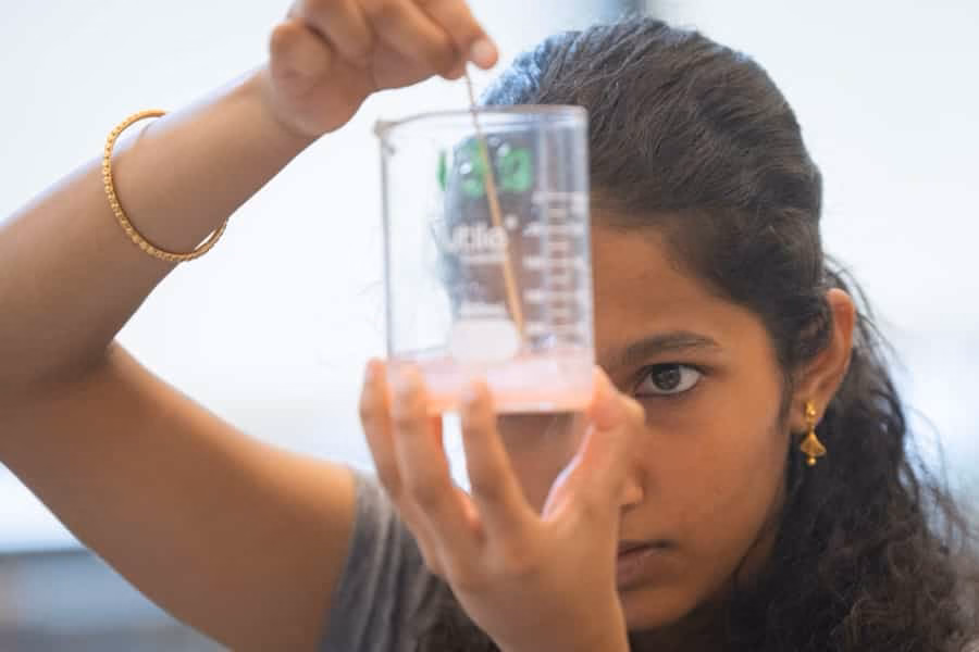 a student mixes substance in beaker