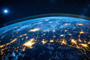 earth at night with lights shining in major areas.