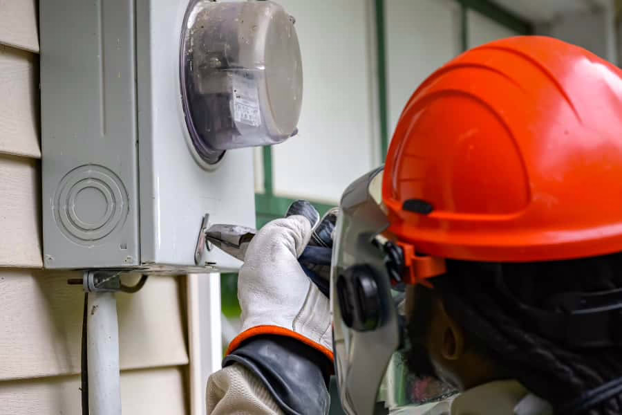 a worker checks a smart meter