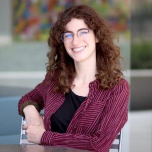 profile of speaker Eliana Stanislawski seated at a table 