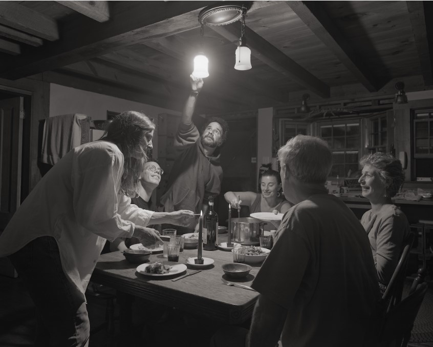 Black and white photo of family around table