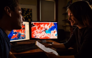 Geography student looking over GIS maps