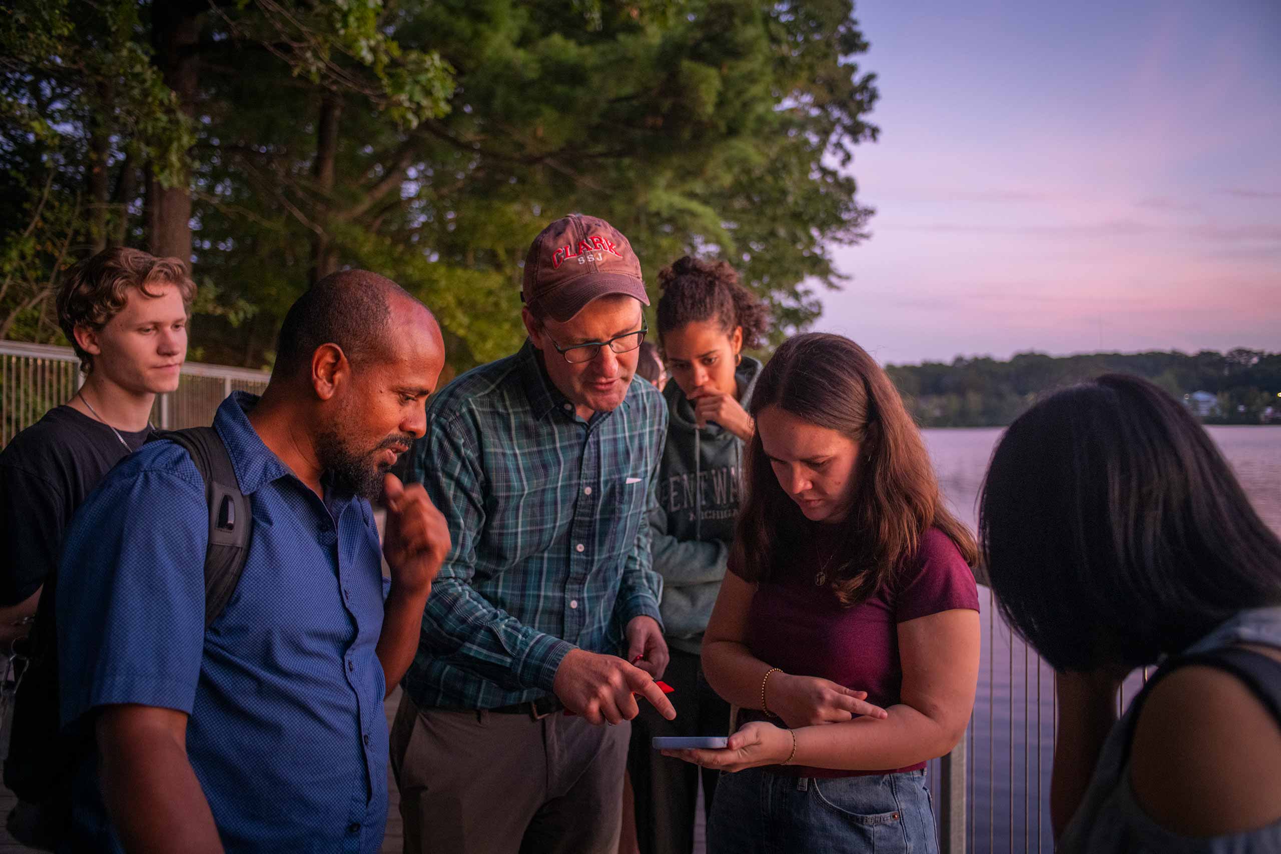 Students gather around professor Morgan Ruelle to ask about the bat monitoring device.