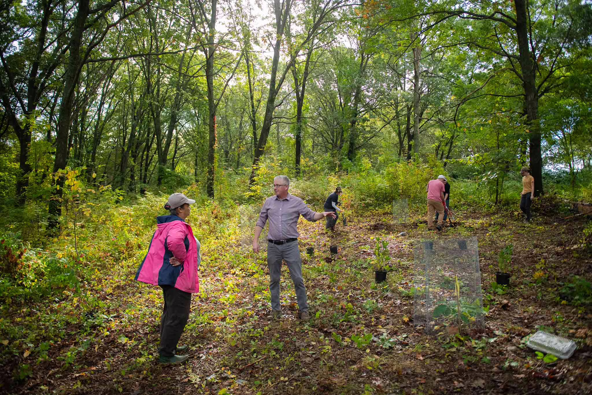 John Rogan and his class work with a member of the local Nipmuc community to plant a traditional garden in the Hadwen Arboretum.