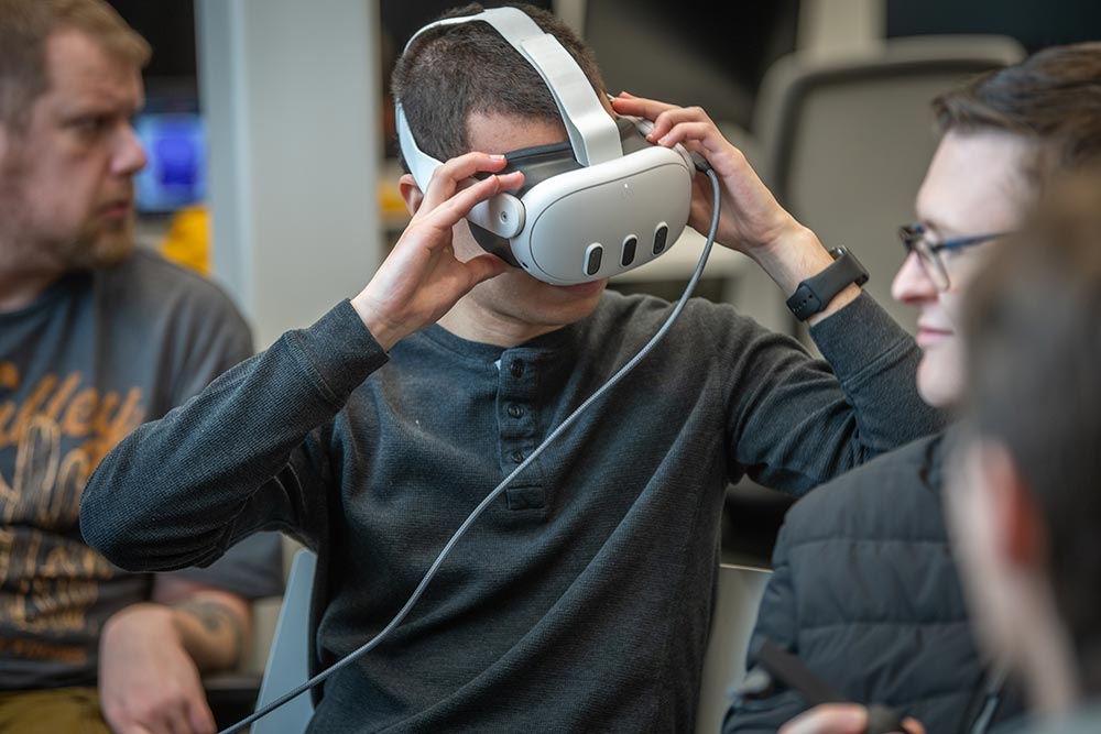 A students in an interactive media course wearing a pair of vr goggles.