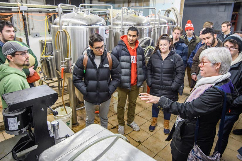 An economics class visiting a production facility