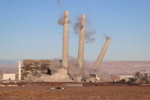 large cement towers coming down in dynamite explosion