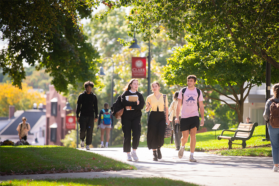 Three students walking together on Clark campus