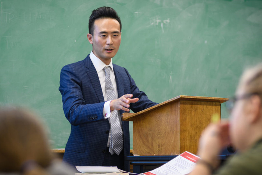 Professor delivering a lecture in an Asian studies class