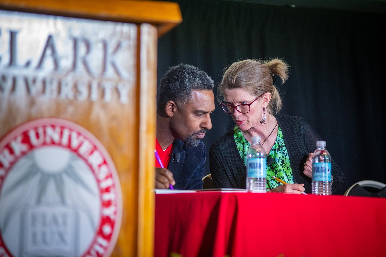 Ousman Power-Greene and and colleague confer at an academic symposium on race, gender, and ethnicity