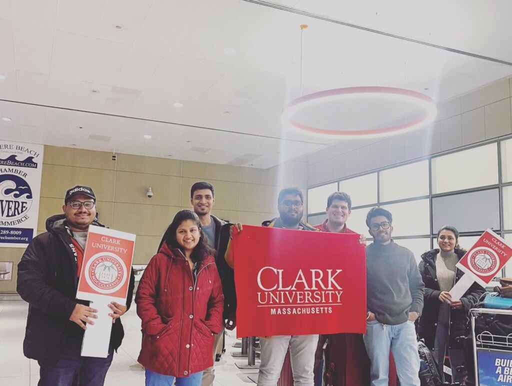 international students holding up clark signs