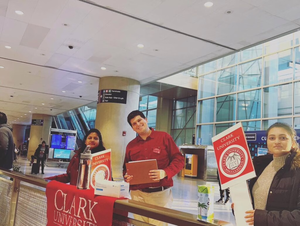 international student holding up signs to welcome everyone
